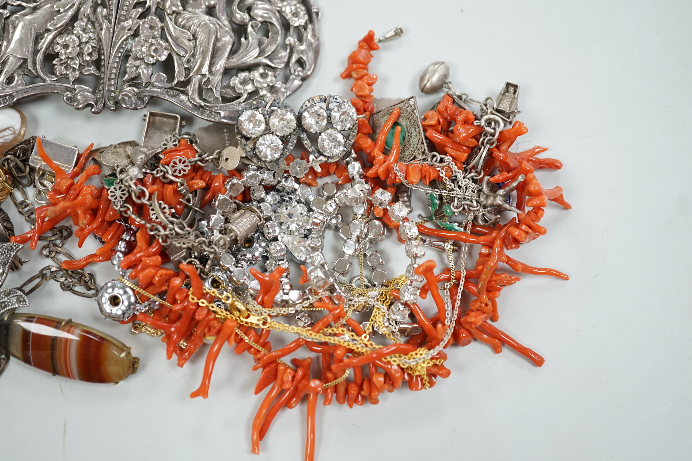 A late Victorian Art Nouveau silver nurses' buckle, William Comyns, London, 1900, 11.9cm and a small group of sundry jewellery including charm bracelet, coral necklace etc.